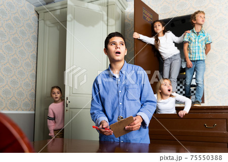 Children try to solve the puzzle to get out of quest room Children try to solve the puzzle to get out of quest room 75550388