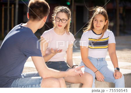 Teenagers have fun talking on the street 75550545