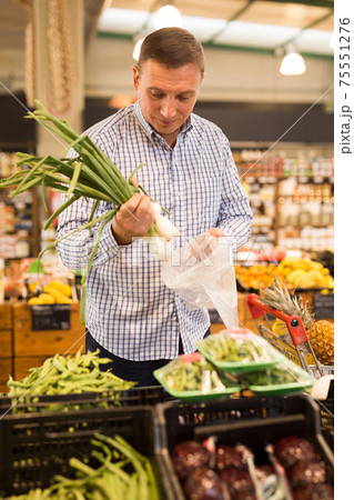 Man buying greens for salad Man buying greens for salad 75551276