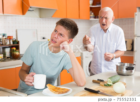 Senior man scolding his teenage grandson Senior man scolding his teenage grandson 75552331