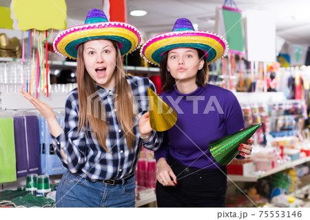 Smiling girls showing funny festival hats 75553146