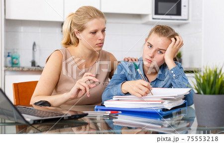 Mother calming her daughter 75553218