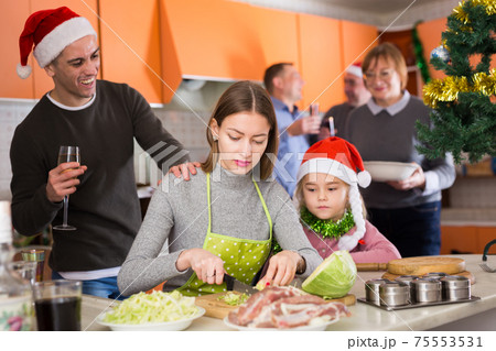 Woman with kid girl preparing family dinner Woman with kid girl preparing family dinner 75553531