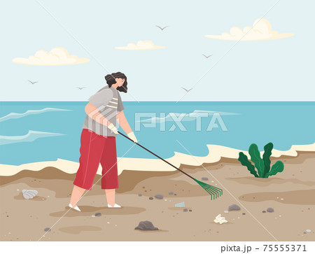 Woman is removing plastic and paper waste with rake on dirty beach and cleaning territory 75555371