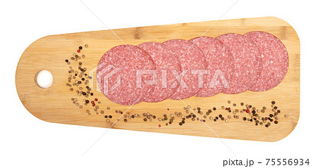 Slices of smoked sausage salami on a wooden serving tray 75556934