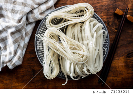 Dried white rice noodles. Raw pasta. Uncooked noodles. 75558012
