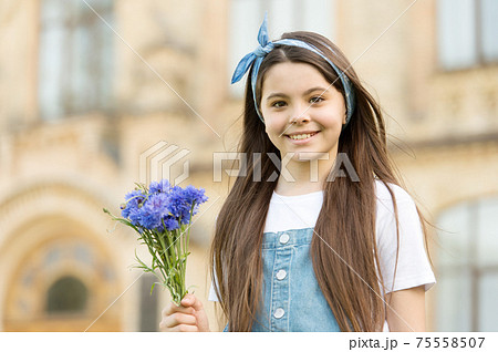 Little girl cornflowers bouquet holiday greetings, mothers day concept Little girl cornflowers bouquet holiday greetings, mothers day concept 75558507
