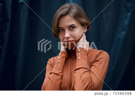 Woman portrait dark background Caucasian female headshoot Woman portrait dark background Caucasian female headshoot 75560398