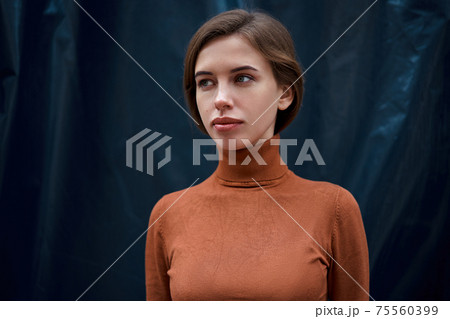 Woman portrait dark background Caucasian female headshoot Woman portrait dark background Caucasian female headshoot 75560399