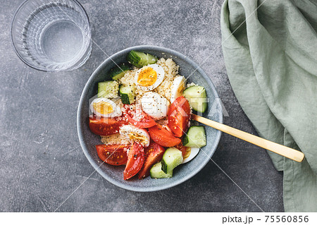 Cous cous salad with cucumber, cherry tomato and quail eggs. 75560856