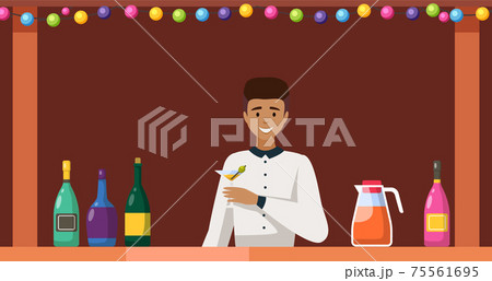 Guy stands with martini in glass and olive. Bartender working in bar is holding alcohol drink 75561695