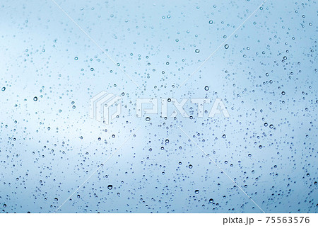 Rain drops on window glass surface. Rainy spring background Rain drops on window glass surface. Rainy spring background 75563576