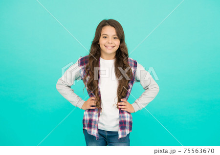 Confident in her style. happy small girl turquoise background. 75563670