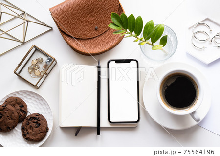 White home office tabletop with smartphone mock-up, coffee cup and notepad 75564196