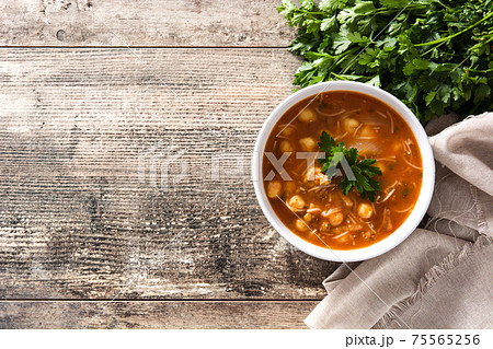 Harira soup in bowl on wooden table. Typical Moroccan food. Ramadan concept. Harira soup in bowl on wooden table. Typical Moroccan food. Ramadan concept. 75565256