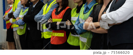Large group of factory worker standing together in warehouse or storehouse 75566020