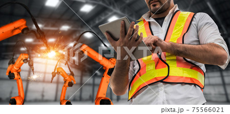 Engineer use advanced robotic software to control industry robot arm in factory 75566021