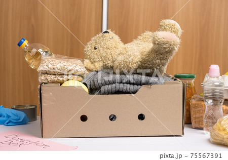 cardboard box with food and things to help those in need cardboard box with food and things to help those in need 75567391