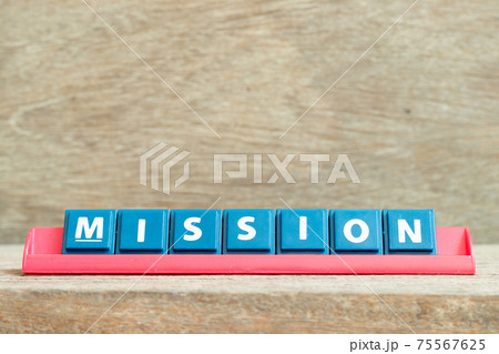 Tile alphabet letter with word mission in red color rack on wood background 75567625