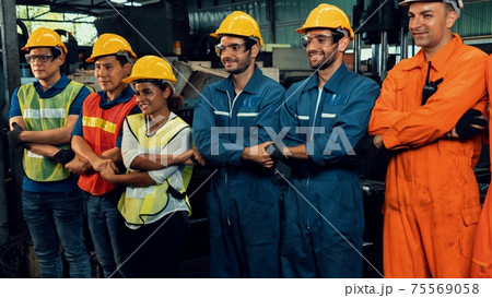 Skillful worker stand together showing teamwork in the factory . 75569058