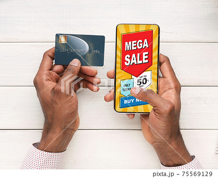 Man using shopping application on smartphone and credit card Man using shopping application on smartphone and credit card 75569129