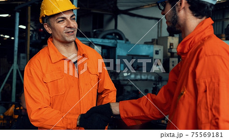 Two skillful factory engineer or worker showing teamwork and partnership . Two skillful factory engineer or worker showing teamwork and partnership . 75569181