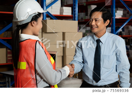 Warehouse manager and worker working in the storehouse 75569336