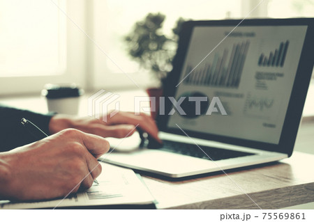 close up. business man works analyzing financial tables . 75569861
