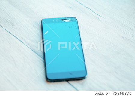 close up. cracked, damaged, broken smartphone LCD screen close up. cracked, damaged, broken smartphone LCD screen 75569870