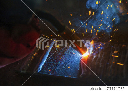 Close-up scene of the electric welding process. The welding operation at construction site. 75571722