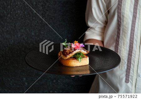 Foie Gras serving with toasted bread and green salad Foie Gras serving with toasted bread and green salad 75571922