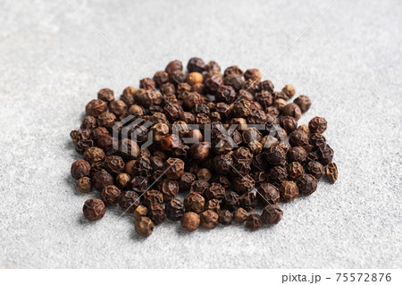Black pepper peas on a gray concrete background, copy space. Black pepper peas on a gray concrete background, copy space. 75572876