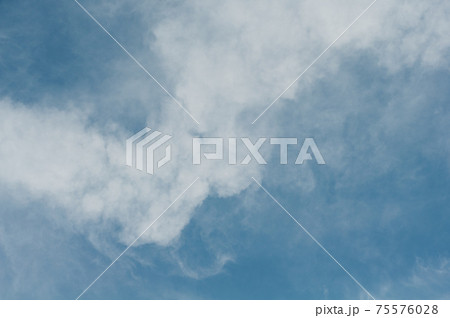 Reflections warm rays setting sun, swirls strong gust wind, outdoors. Bright blue sky, white translucent feathery clouds. Reflections warm rays setting sun, swirls strong gust wind, outdoors. Bright blue sky, white translucent feathery clouds. 75576028