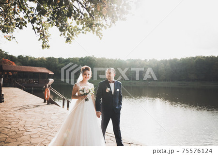 Kissing wedding couple in spring nature close-up portrait Kissing wedding couple in spring nature close-up portrait 75576124