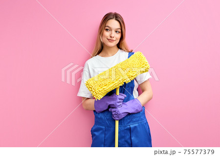 smiling lady confident house wife in good mood hold cleaning equipment isolated on pink smiling lady confident house wife in good mood hold cleaning equipment isolated on pink 75577379