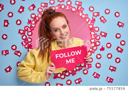 Beautiful redhead female holding FOLLOW ME sign, ask to be more active in Internet, send likes and messages Beautiful redhead female holding FOLLOW ME sign, ask to be more active in Internet, send likes and messages 75577859