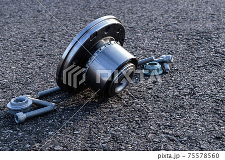 Car parts. Set of new metal car part. Auto motor mechanic spare or automotive piece isolated on black ground asphalt texture. Technology of mechanical gear. 75578560