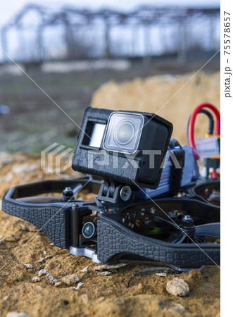 A Brand-New Modern Cinewhoop Iflight Protek 35 with GoPro Action Camera on Board Outdoors in the Grass 75578657