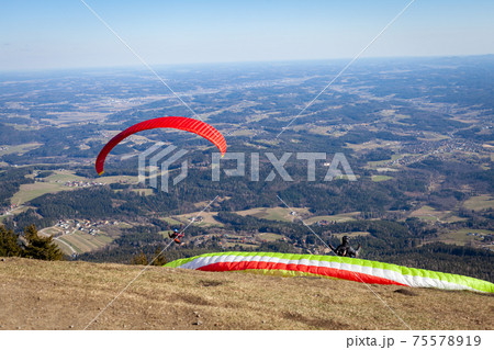 sports paragliding on a parachute over the countryside 75578919