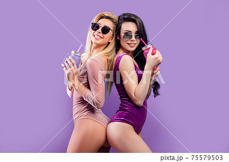 Hot women in bodysuits standing together with colorful drinking jars 75579503