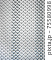 Old metal steel springy mesh with chain link on a beige background 75580998
