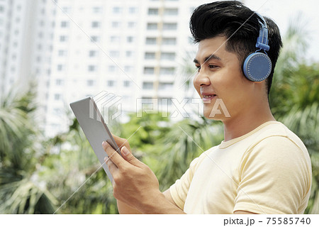 Man watching movie online Man watching movie online 75585740