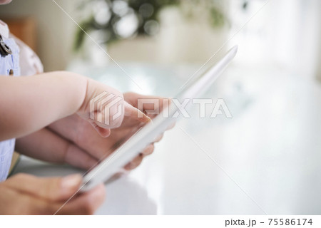 Baby pointing at tablet Baby pointing at tablet 75586174