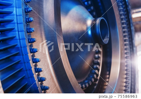 The rotor disk with the blades of a turbojet gas turbine engine with a blue glow. The rotor disk with the blades of a turbojet gas turbine engine with a blue glow. 75586963