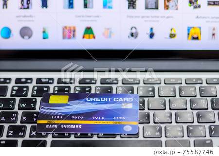 Blue credit card mockup put on keyboard of laptop and blurred web shopping online 75587746