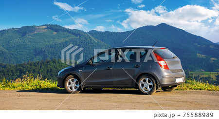 mizhhirya, ukraine - AUG 08, 2020: car on the concrete parking on top of the mountain in morning light. travel countryside concept. beautiful nature scenery views in summer with clouds on the blue sky mizhhirya, ukraine - AUG 08, 2020: car on the concrete parking on top of the mountain in morning light. travel countryside concept. beautiful nature scenery views in summer with clouds on the blue sky 75588989