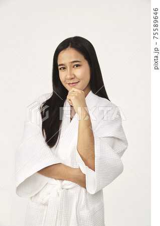 Beautiful girl wearing white bathrobe 75589646