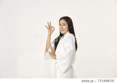 Beautiful girl wearing white bathrobe 75589650