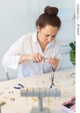 Professional accessories designer making handmade jewelry in studio workshop. Fashion, creativity and handmade concept. 75590692