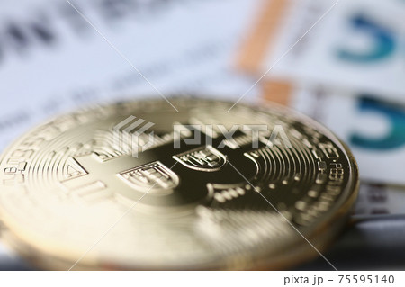 Gold bitcoin lies on table. Making money on bitcoins without investments Gold bitcoin lies on table. Making money on bitcoins without investments 75595140